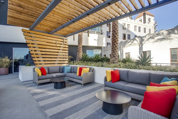 Patio lounge with modern seating and ocean views at Oceanaire Apartments, a Greystar luxury property in a coastal setting