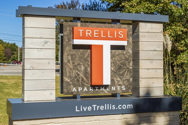 Trellis Apartments: Welcoming sign featuring website LiveTrelliscom in a lush garden setting