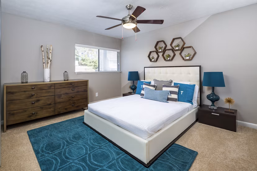 Cozy bedroom featuring modern decor and large windows in Trellis Apartments