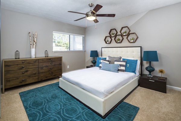 Cozy bedroom featuring modern decor and large windows in Trellis Apartments