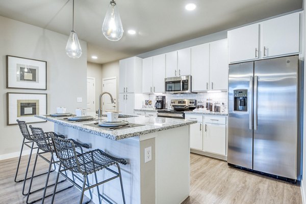 Modern kitchen with stainless steel appliances and granite countertops at Citadel at Lookout Apartments Perfect for culinary enthusiasts