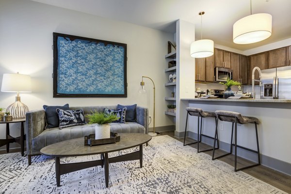 Spacious living room with stylish furniture and natural light in Verde at McCullough Station Apartments