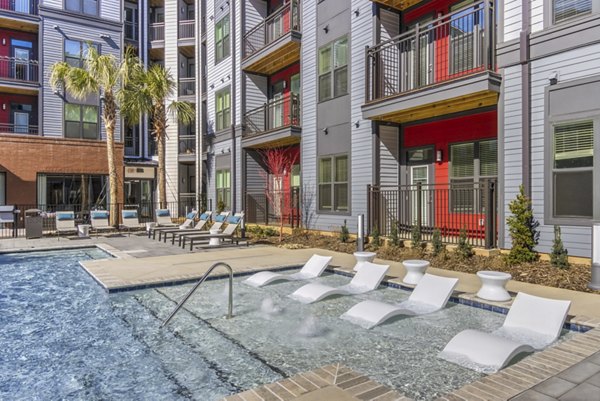 Rooftop pool with lounge area at Verde at McCullough Station Apartments, offering luxury leisure and skyline views