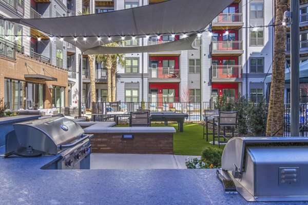 Outdoor BBQ space with modern grills at Verde at McCullough Station Apartments