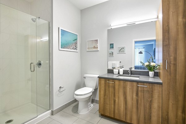 Bathroom featuring modern fixtures and elegant decor at Miscela Apartments