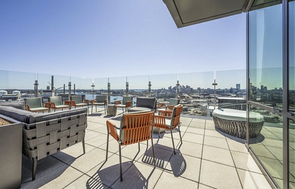 Spacious balcony with modern seating at Miscela Apartments offering city views