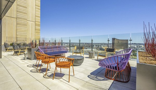 Private patio with stylish seating at Miscela Apartments, offering city views and relaxing outdoor space for residents