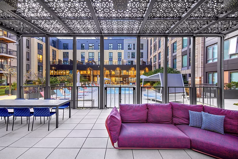Fire pit and seating area on the cozy patio at Miscela Apartments, offering a relaxing outdoor space for residents