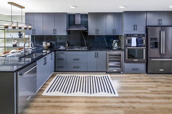 Clubhouse kitchen with modern appliances and island seating at Ascent Peachtree Apartments