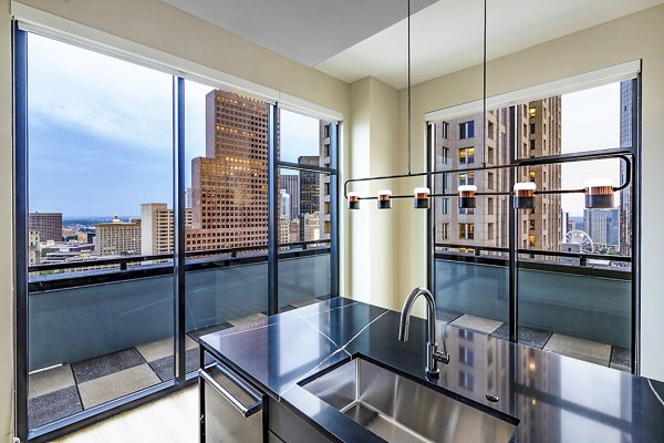 Kitchen featuring modern island and stainless steel appliances at Ascent Peachtree Apartments