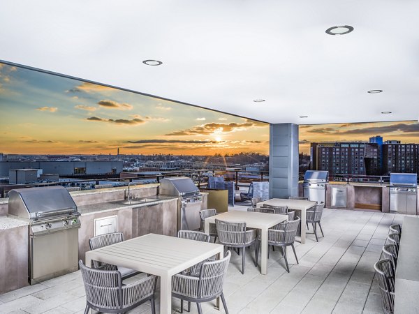 Grill area with modern BBQ facilities at Rowan Apartments in a luxurious outdoor setting for social gatherings