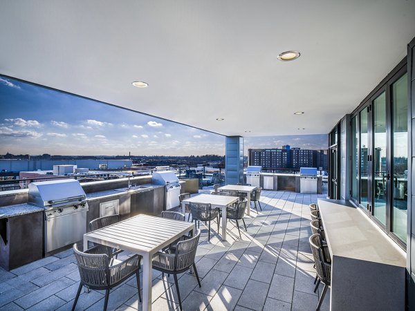 Grill area with modern barbecue stations at Rowan Apartments, a luxury Greystar community