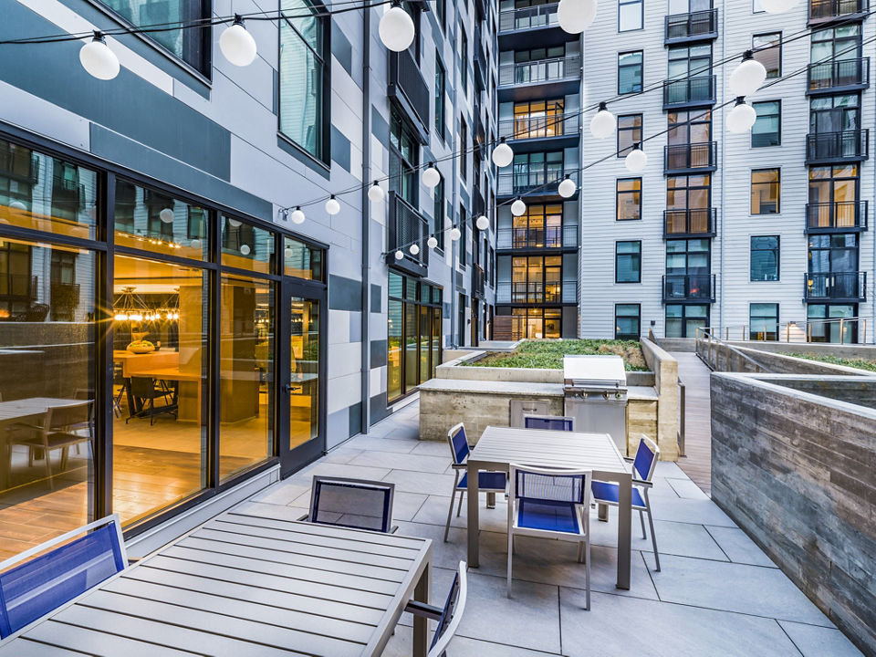 Outdoor grill area with modern amenities at Rowan Apartments