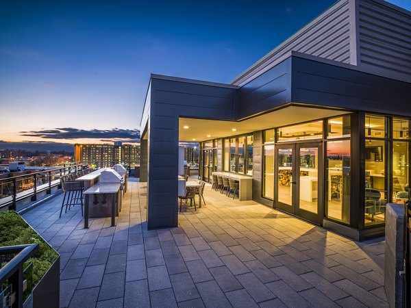 Modern grill area with community seating at Rowan Apartments, a Greystar luxury living community