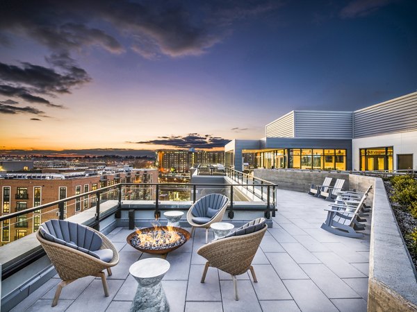 Fire pit patio with cozy seating at Rowan Apartments