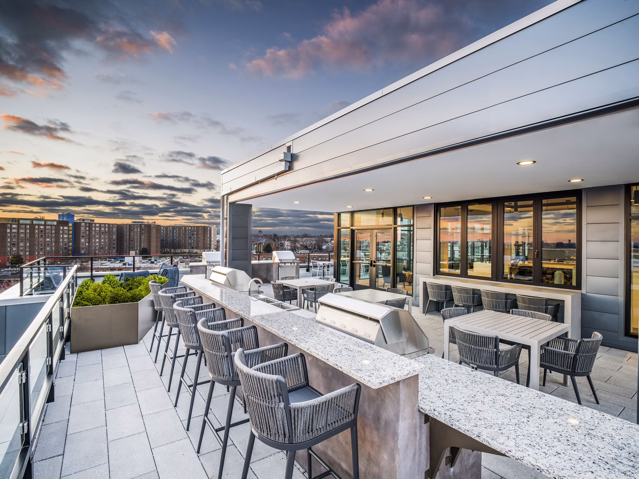 Rowan Apartments: Modern grill area in luxury outdoor space