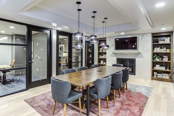 Game room featuring pool tables and arcade games at The Bower Apartments