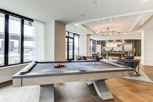 Game room featuring modern pool table and lounge seating at The Bower Apartments