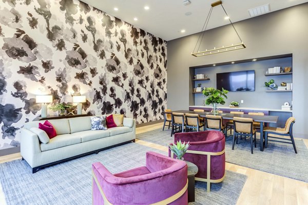 Clubhouse featuring modern decor and ample seating at The Bower Apartments, ideal for social gatherings and community events