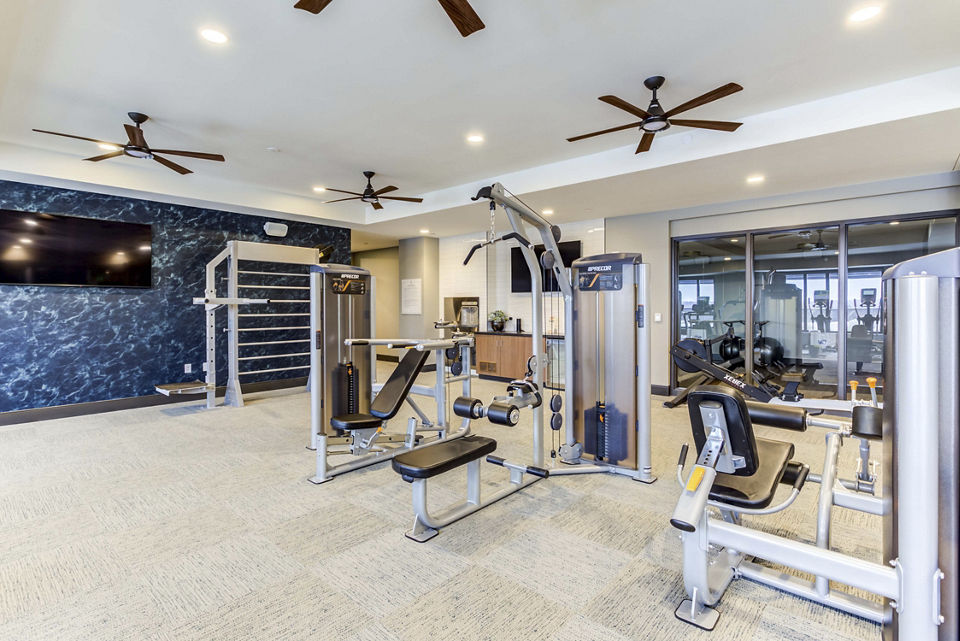 State-of-the-art fitness center at The Bower Apartments offering modern workout equipment and spacious exercise areas for residents