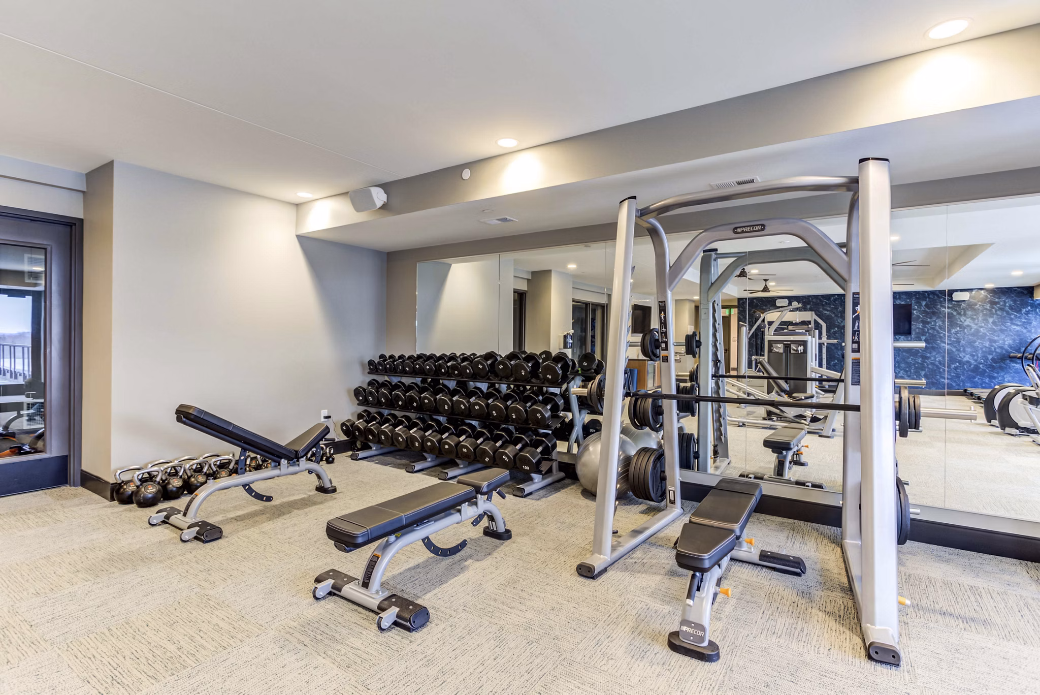 Fully equipped fitness center at The Bower Apartments with state-of-the-art machines and weights, perfect for residents seeking active lifestyles