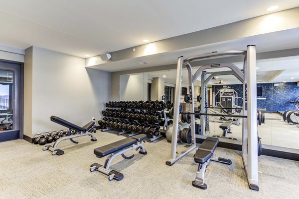 Fully equipped fitness center at The Bower Apartments with state-of-the-art machines and weights, perfect for residents seeking active lifestyles