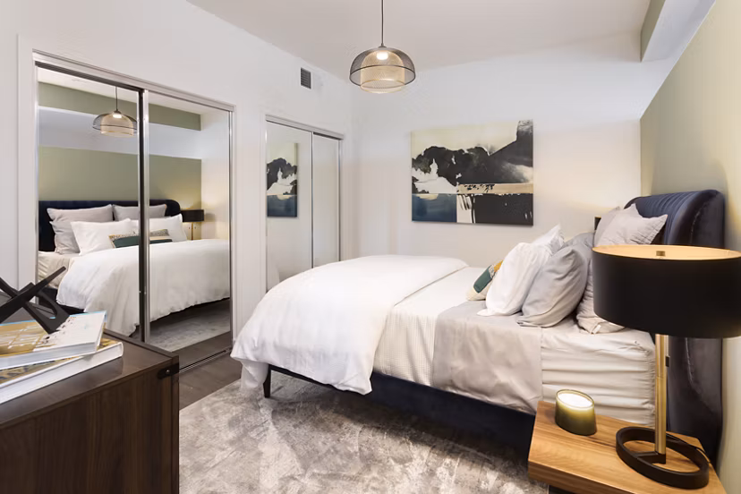 Cozy bedroom with modern decor at Alexan Gallerie Apartments