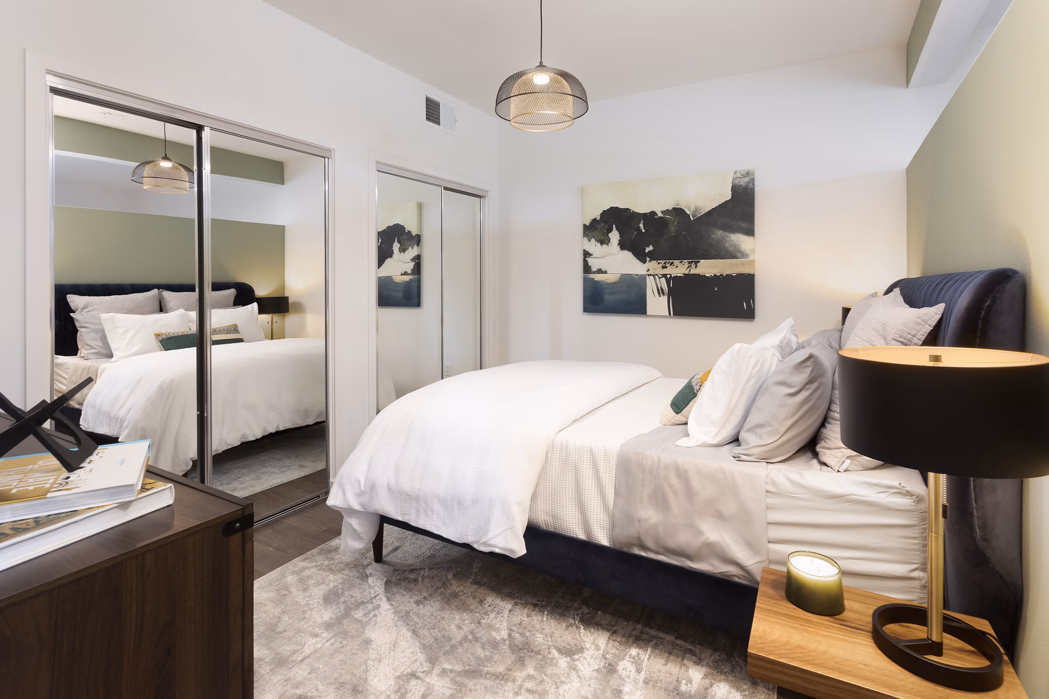 Cozy bedroom with modern decor at Alexan Gallerie Apartments