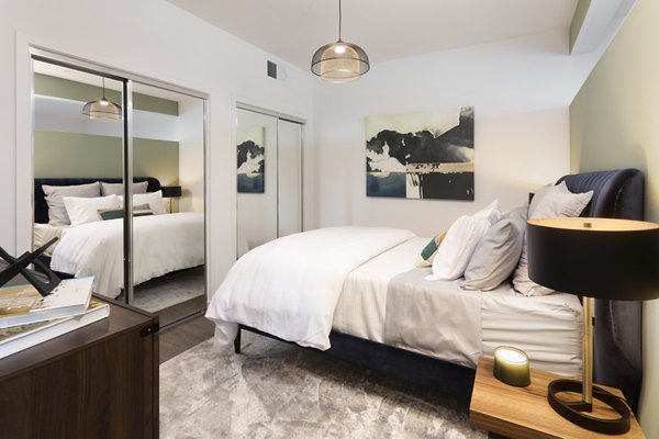 Cozy bedroom with modern decor at Alexan Gallerie Apartments