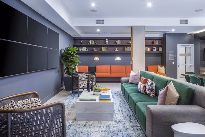 Modern clubhouse with stylish seating and entertainment options at Alexan Gallerie Apartments, a Greystar luxury living community