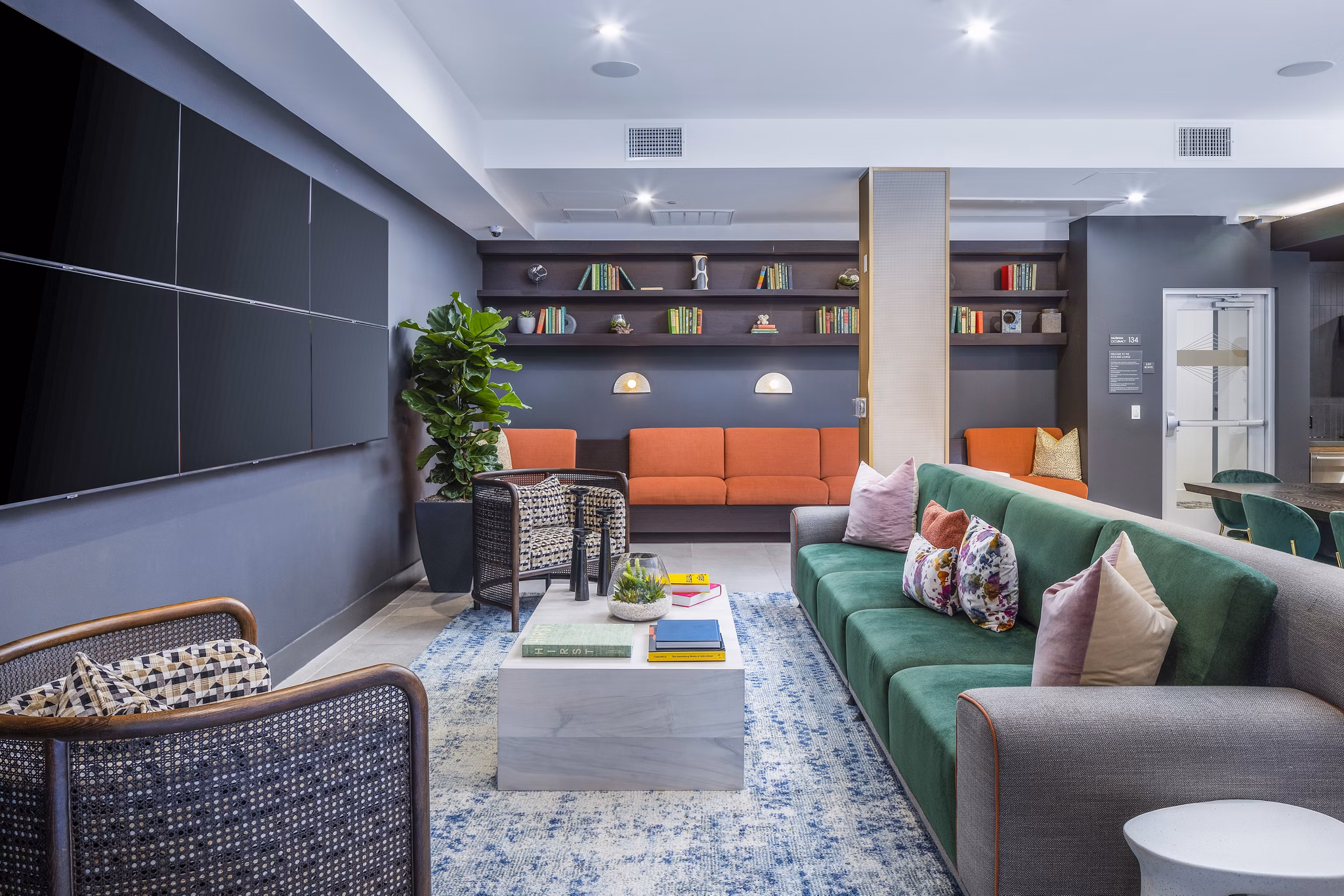 Modern clubhouse with stylish seating and entertainment options at Alexan Gallerie Apartments, a Greystar luxury living community
