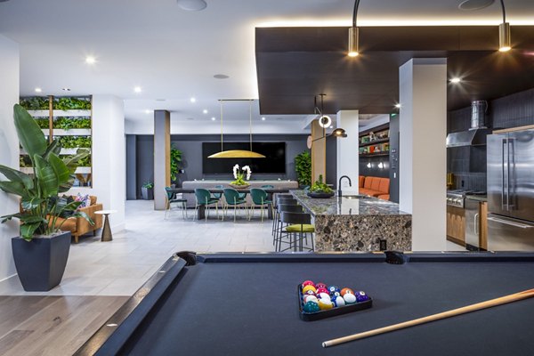Game room featuring modern decor and pool table at Alexan Gallerie Apartments in luxury community