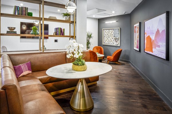 Clubhouse featuring modern decor and comfortable seating at Alexan Gallerie Apartments, luxury living space in prime location