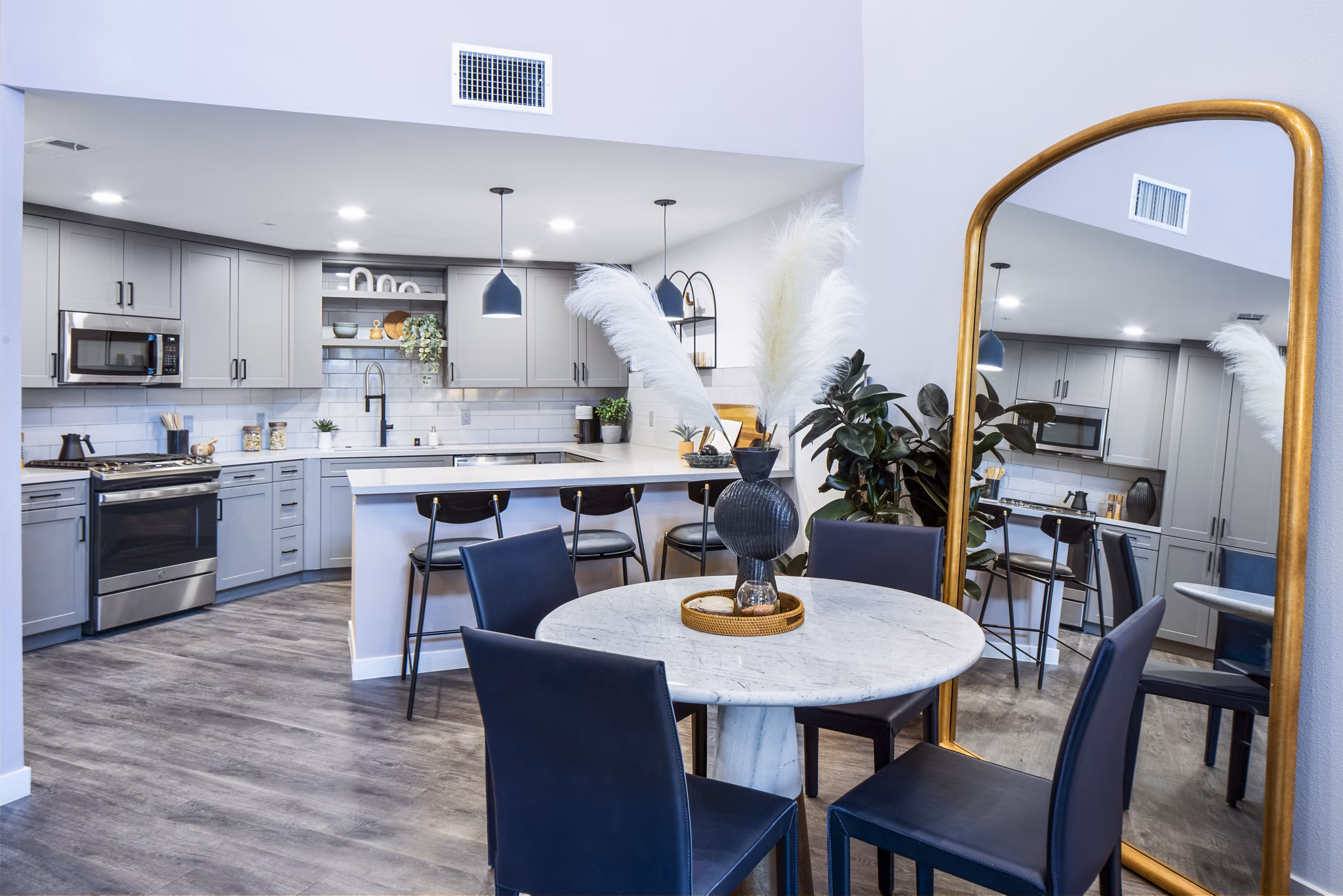 Elegant dining room featuring modern decor and large windows in Alexan Gallerie Apartments, ideal for luxury living experiences