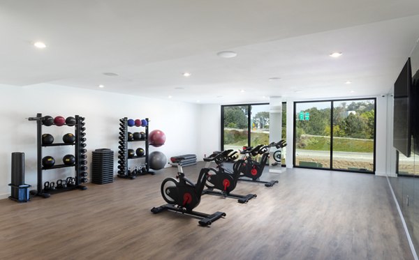 Yoga and spin studio with modern equipment at Alexan Gallerie Apartments