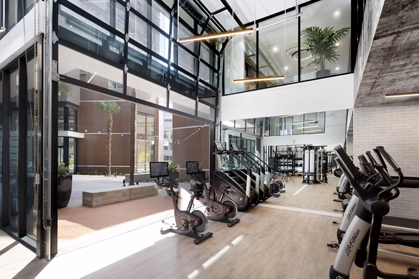 State-of-the-art fitness center at Alexan Gallerie Apartments featuring modern equipment and spacious workout areas