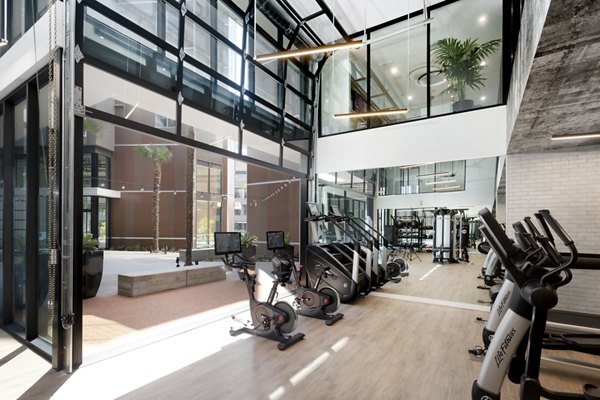 State-of-the-art fitness center at Alexan Gallerie Apartments featuring modern equipment and spacious workout areas