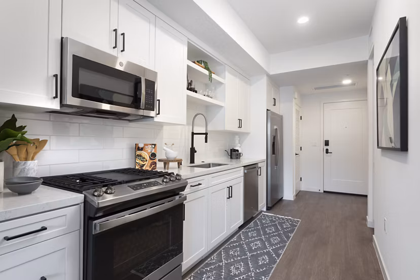Modern kitchen with stainless steel appliances at Alexan Gallerie luxury apartments