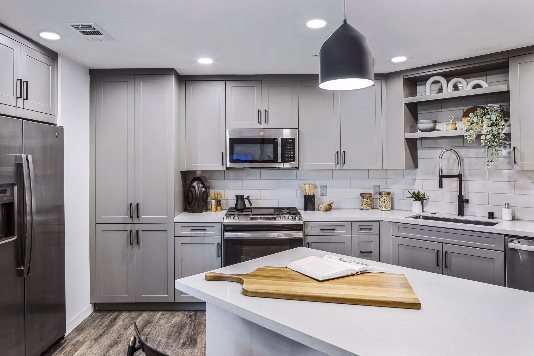Modern kitchen with stainless steel appliances in Alexan Gallerie Apartments