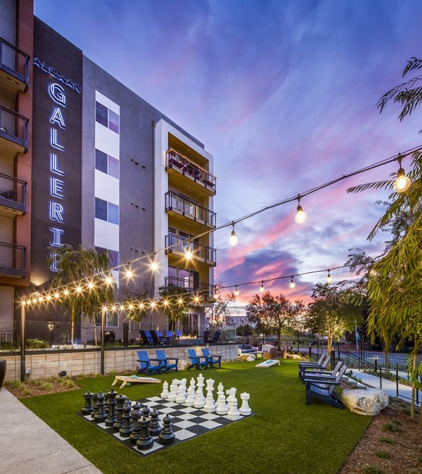 Recreational area with outdoor seating and green space at Alexan Gallerie Apartments
