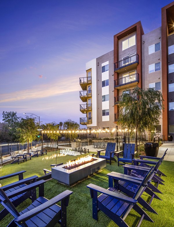 Outdoor fire pit and grill area at Alexan Gallerie Apartments offering luxury amenities for residents to enjoy