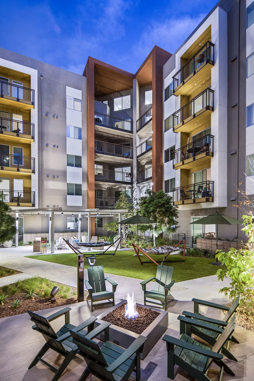 Outdoor fire pit and grill area at Alexan Gallerie Apartments, ideal for social gatherings and relaxation