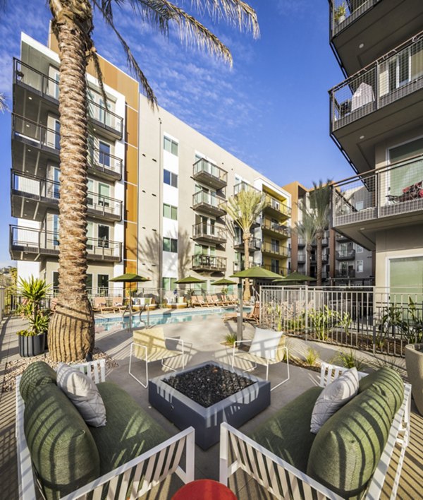 Cozy fire pit area at Alexan Gallerie Apartments, ideal for social gatherings and relaxation outdoors