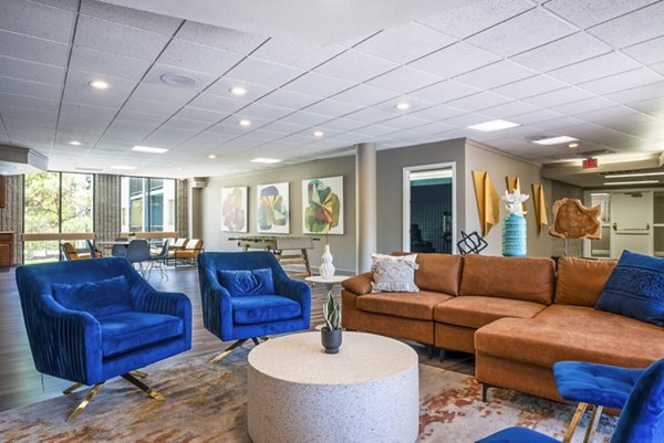 Clubhouse at Glo Apartments featuring spacious lounge and pool table