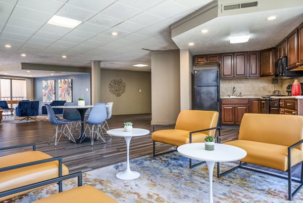 Elegant clubhouse at Glo Apartments featuring modern design and ample seating for community events in luxury living environment