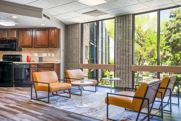 Modern clubhouse with stylish seating and entertainment options at Glo Apartments, offering luxury living in a vibrant community