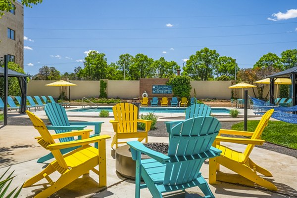 Fire pit and cozy seating area on patio at Glo Apartments, a luxury community offering modern amenities in a vibrant Los Angeles neighborhood