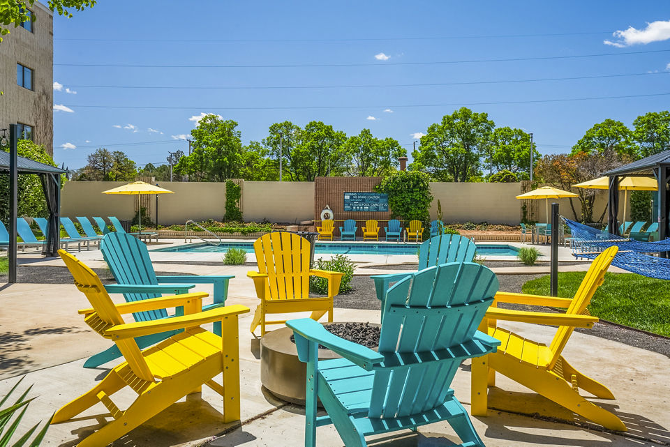Fire pit and cozy seating area on patio at Glo Apartments, a luxury community offering modern amenities in a vibrant Los Angeles neighborhood