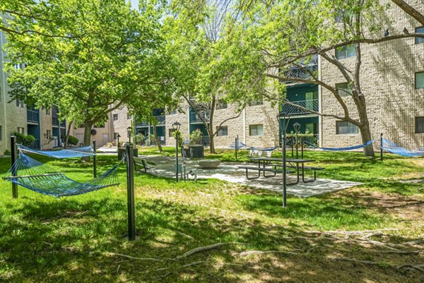 Outdoor grill and hammock area at Glo Apartments, offering a relaxing retreat in a luxury setting