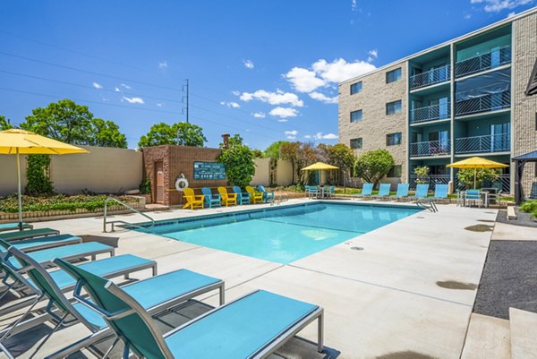 Luxurious swimming pool with lounge areas at Glo Apartments, ideal for relaxation and leisure in a vibrant urban setting